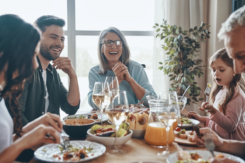 Happy multi-generation family communicating and smiling while ha Luxury dual occupancy home designs: The future of multigenerational living